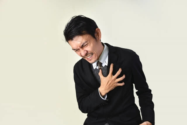 胸を押さえる男性.jpg